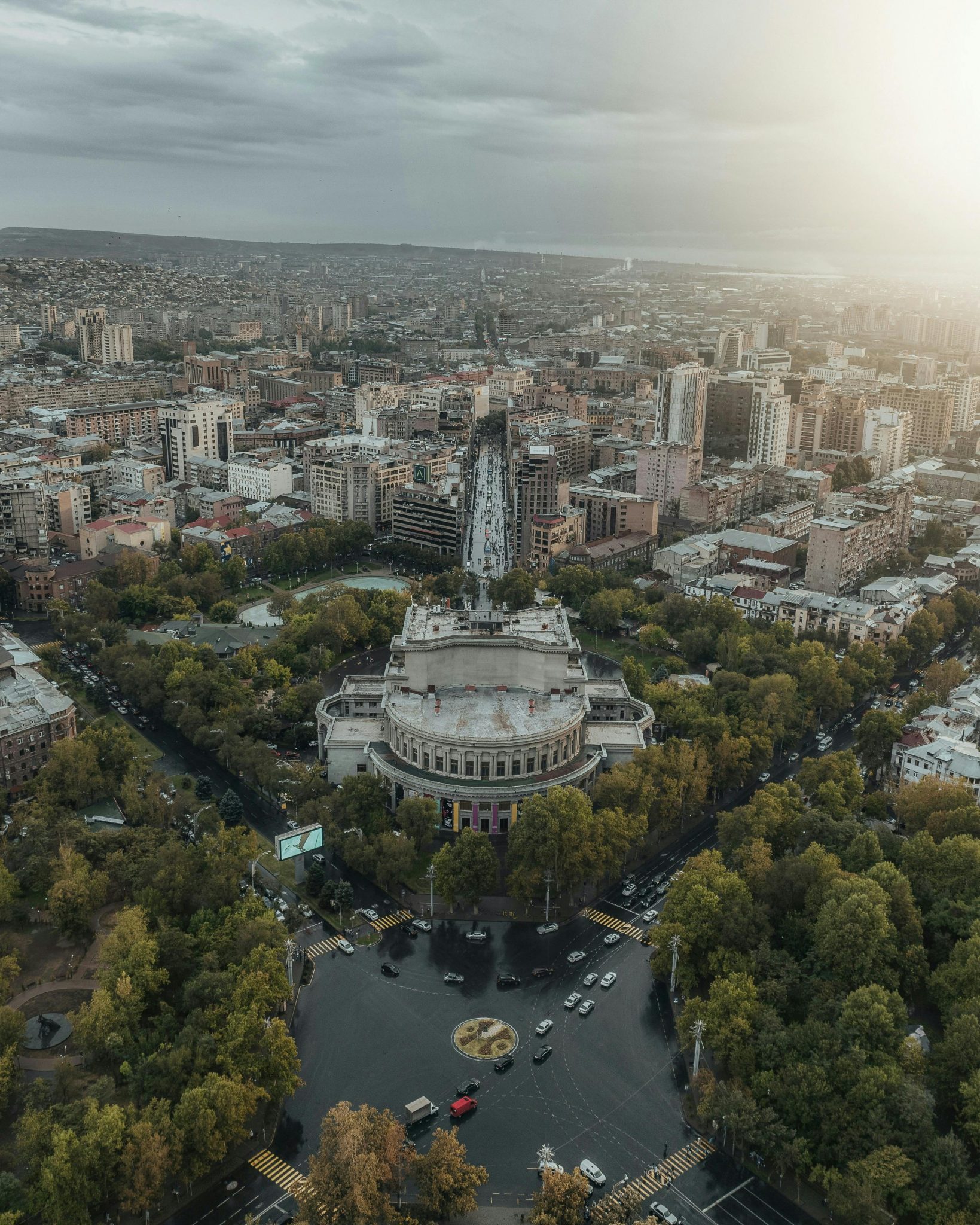 Stunning aerial shot of Yerevan, Armenia, showcasing the Cascade Complex with a vibrant sunset.